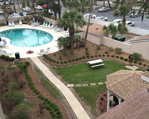 An outdoor swimming pool surrounded by trees.
