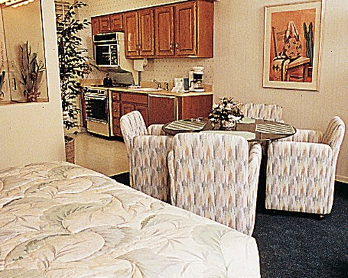 An open plan dining and kitchen area with a bed.