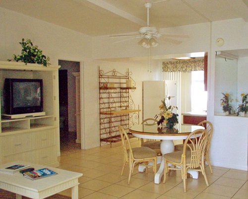 An open plan dining and living area with a television.