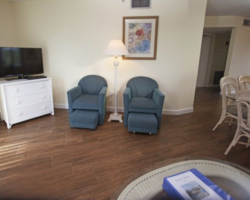 An open plan kitchen and living area with television.