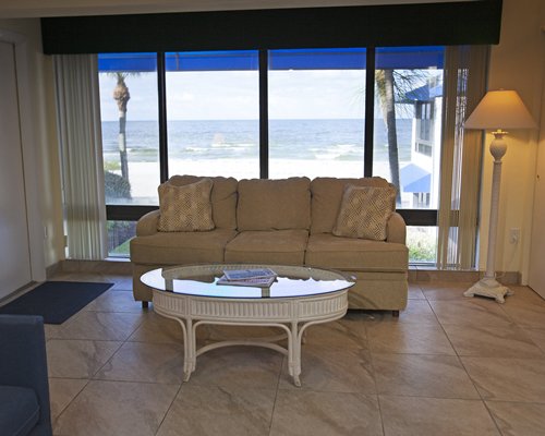 A well furnished living room with a double pull out sofa and an outdoor view.
