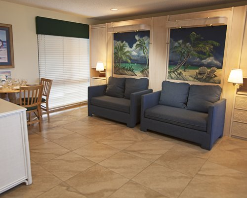 An open plan living room with two sofas and dining area.