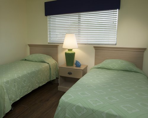 A well furnished bedroom with two twin beds.