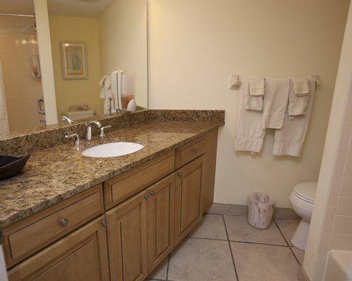 A bathroom with shower and vanity.