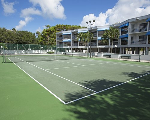 View of multiple unit balconies with outdoor tennis court.