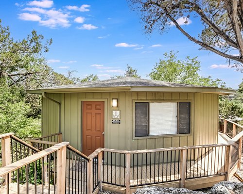Exterior view of the treehouse with wooden deck.