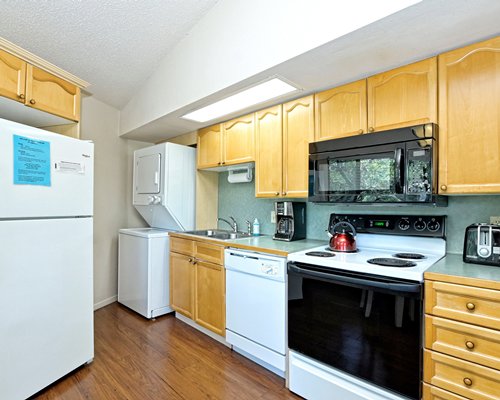 An open plan kitchen with wooden dining area.