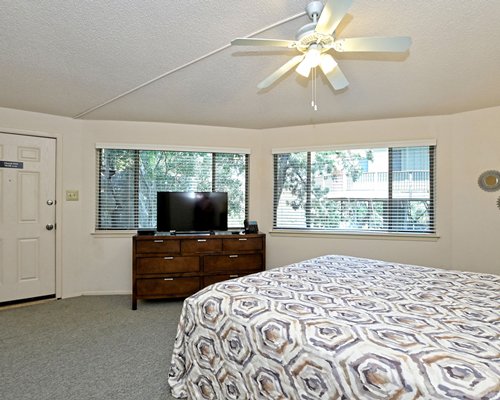 Furnished bedroom with a bed and vanity.