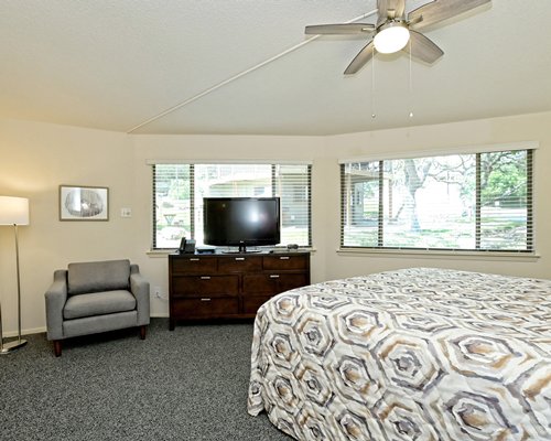 A well furnished bedroom with a king bed and an outside view.