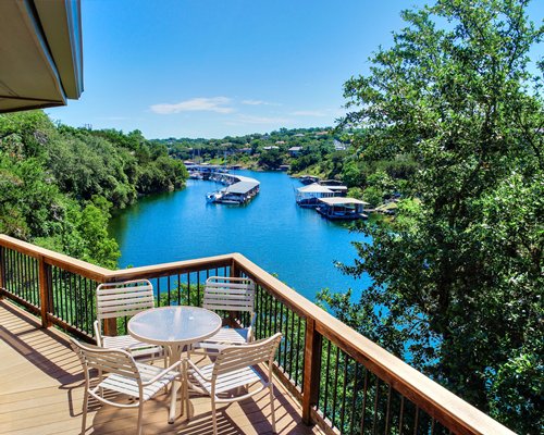 A distant view of the Texas Timeshare resort surrounded by a wooded area and a lake.