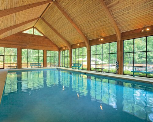 A large indoor swimming pool with an outside view.