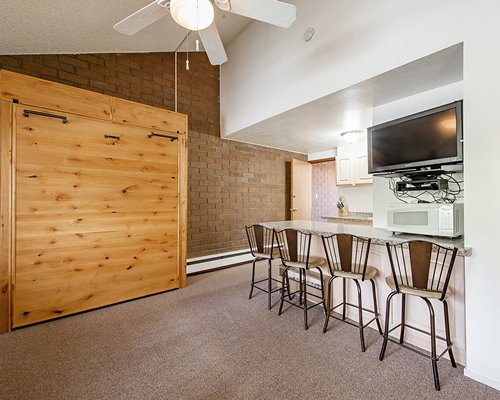 Four seated wooden dining alongside the kitchen.