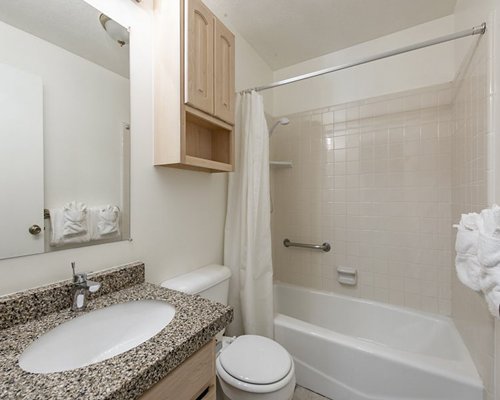 A well furnished bedroom with a queen bed and an outside view.