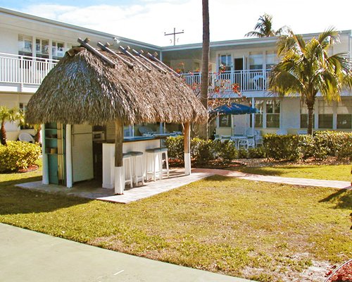 A scenic view of thatched sunshades alongside resort units.