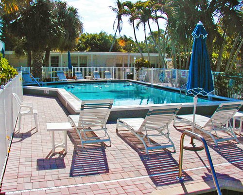 An outdoor swimming pool with chaise lounge chairs.