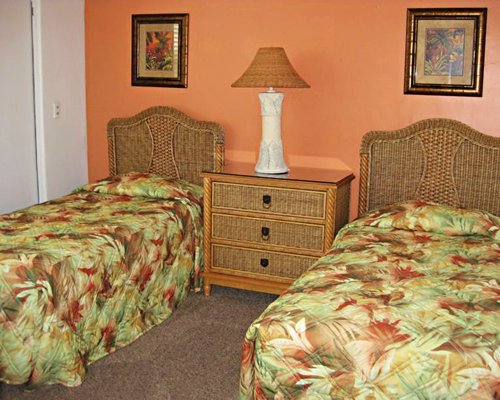 A well furnished bedroom with two twin beds.
