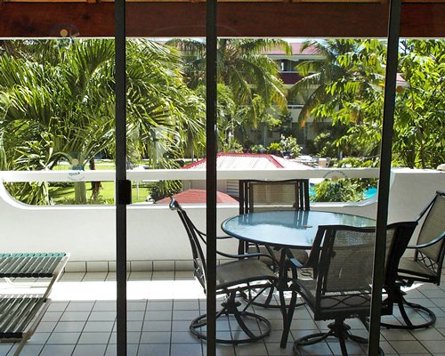 Interior view of a balcony with patio furniture.