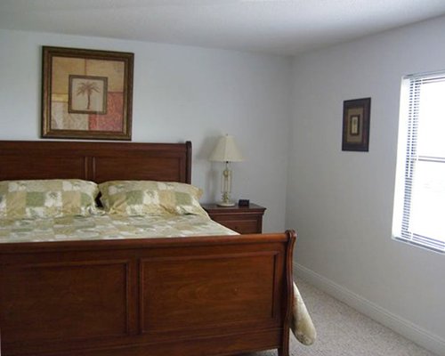 A well furnished bedroom with a bed and an outside view.