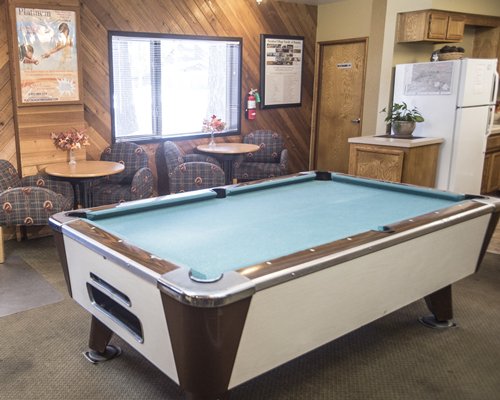 Indoor recreational room with pool table.