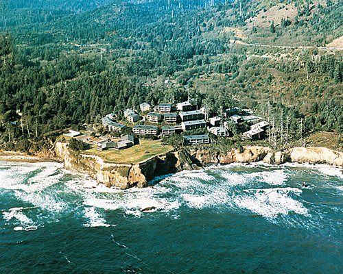 An aerial view of Otter Rock Timeshares Resort surrounded by a wooded area.