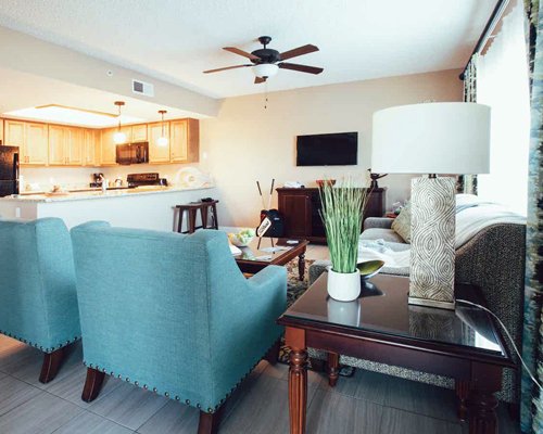 A well furnished living room with open plan kitchen.