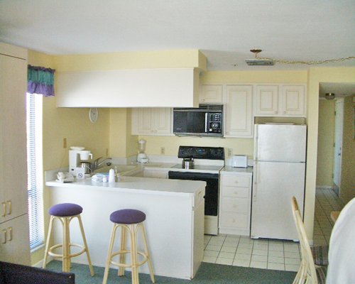 A well equipped kitchen and breakfast bar.