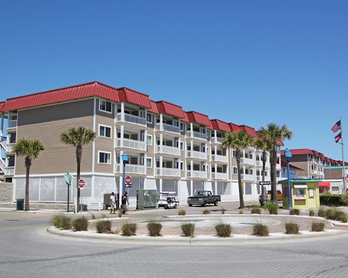 Exterior view of Tybrisa at the Beach with palm trees.