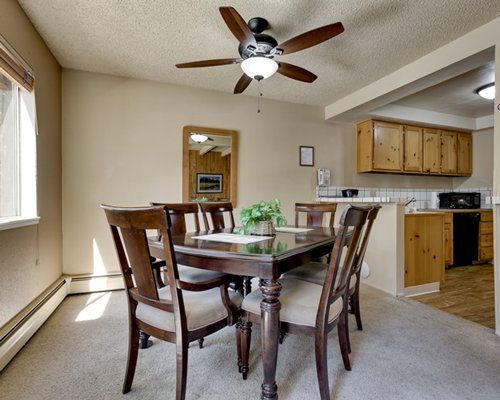 Living room with fire in the fireplace and open plan kitchen.