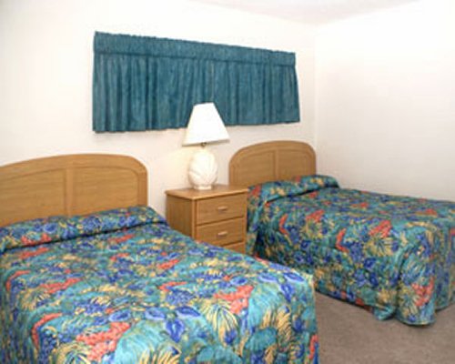 A well furnished bedroom with two double beds.