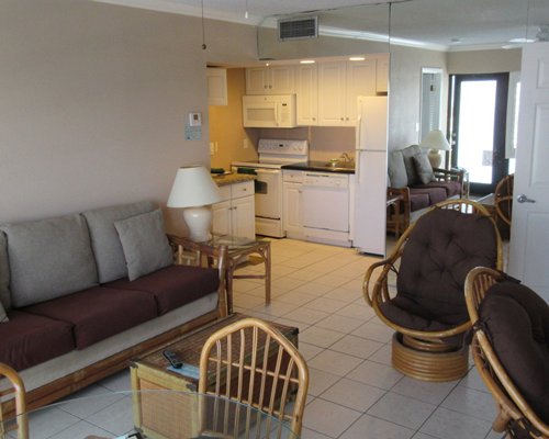 An open plan living dining and kitchen area with a breakfast bar.