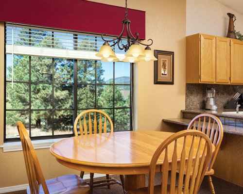 An open plan kitchen with dining area and outside view.