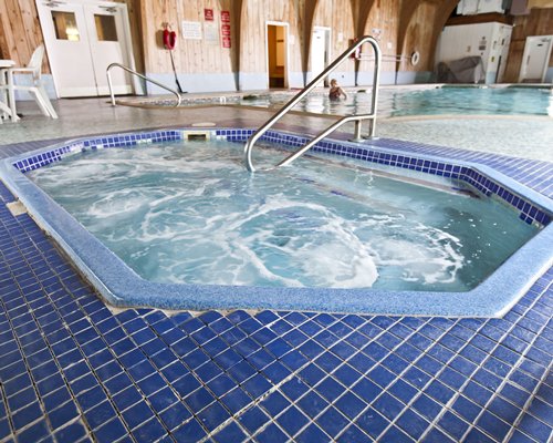 An indoor hot tub alongside swimming pool.