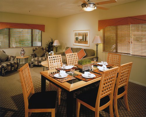 A well furnished living area alongside a dining table.