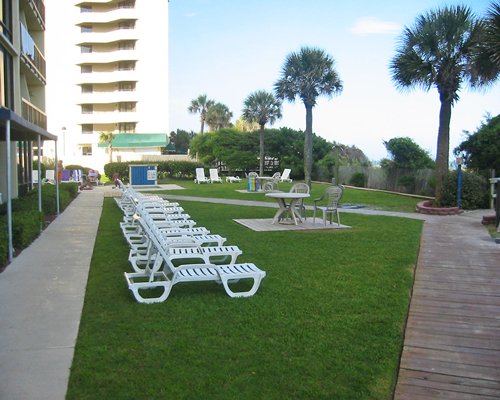 A view of chaise lounge chairs alongside resort units.