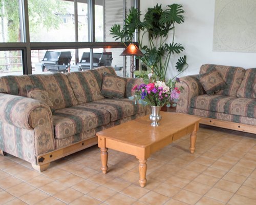 A well furnished living room with pull out sofa and an outside view.