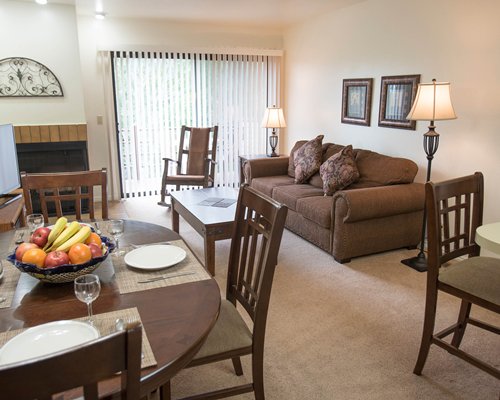 An open plan dining and living room with a fireplace.