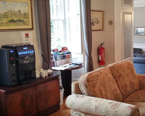 Living room with coffee maker and bookshelf.