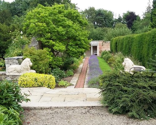 Landscaping surrounded by a wooded area.