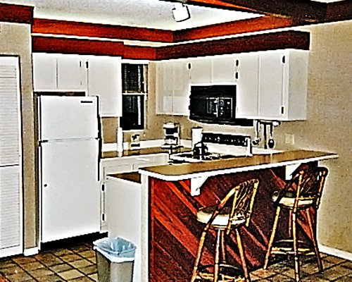A well equipped kitchen and breakfast bar.
