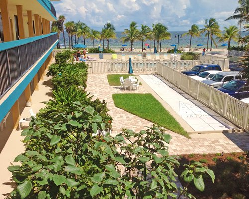 A scenic view of a multi story resort unit alongside a parking area.