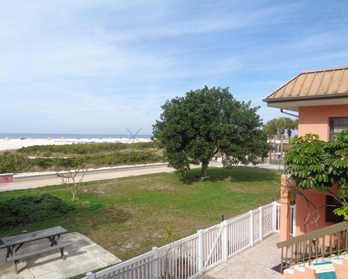 Resort exterior with picnic table overlooking boardwalk and beach.