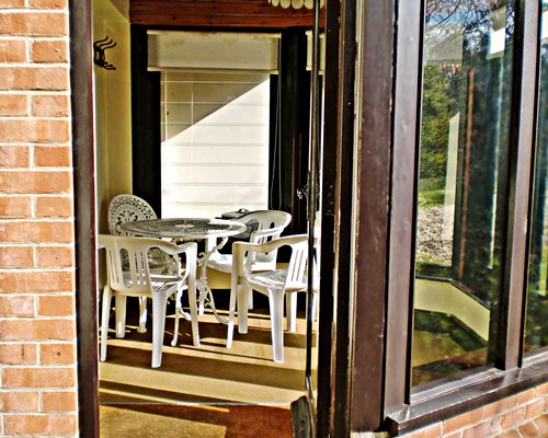 Exterior view of closed patio with patio furniture and outdoor view.