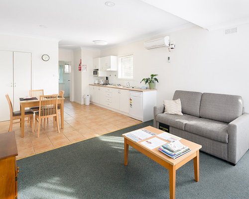 An open plan living dining and kitchen area with a double pull out sofa.
