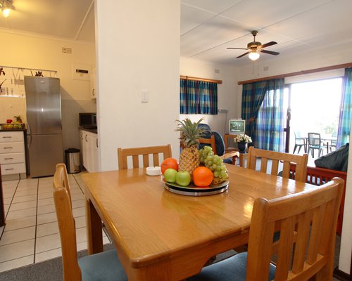 An open plan living dining and kitchen area with an outdoor view.