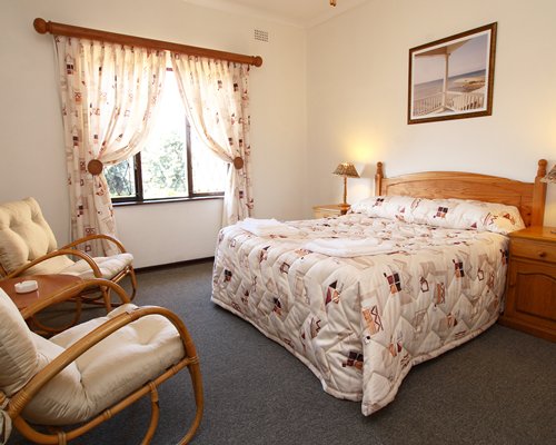 A well furnished bedroom with an outside view.