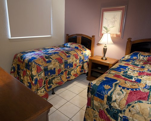 A well furnished bedroom with two twin beds.