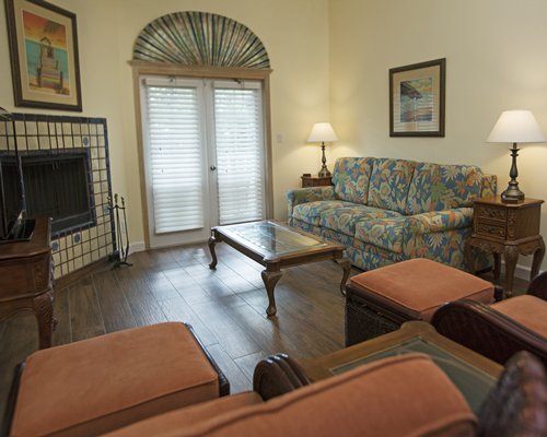Wood floored living room with pull out sofa and fireplace.