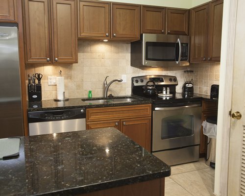 A well equipped modular kitchen with a microwave.