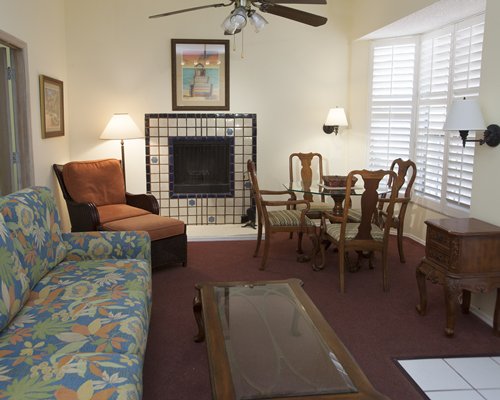 An open plan living and dining area with a fireplace.