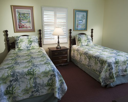 A well furnished bedroom with two twin beds.